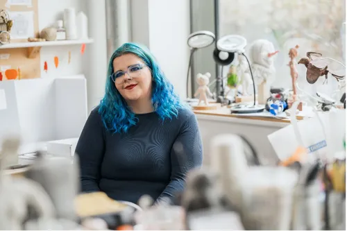 Student sat behind a desk smiling