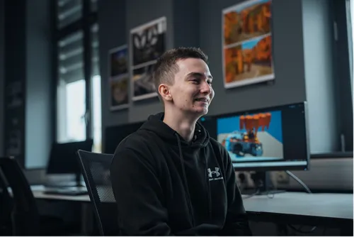Lewis Hobbs looking away from the camera smiling