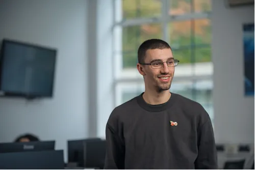 Accounting student Adam smiles for a profile shot