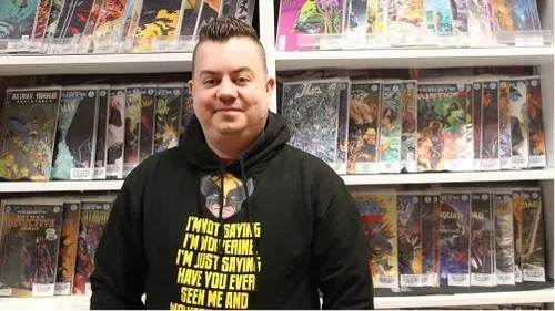 Graduate and business owner Shane poses for a photo in his shop
