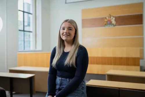 Law student, Holly, smiles at the camera for a profile shot.