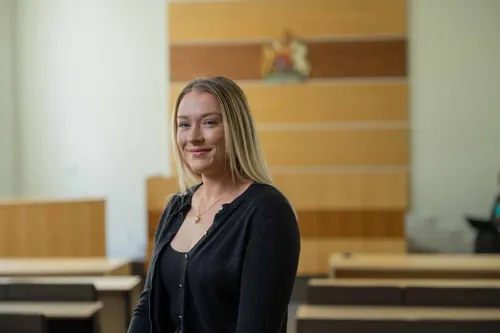 Law student, Stephanie, smiles at the camera for a profile shot.
