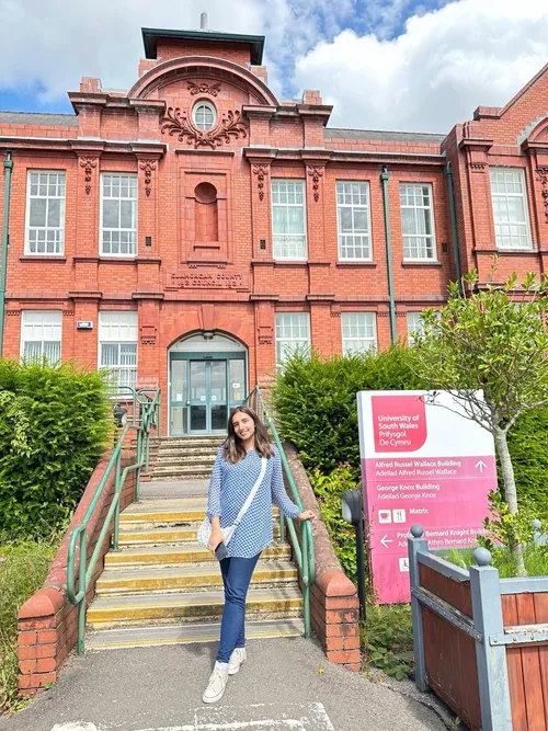 Amna Imran standing outside Glyntaff campus smiling at the camera