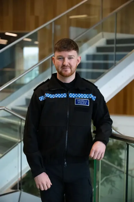 Professional Policing graduate, Andre, poses for a profile picture whilst wearing his South Wales police uniform