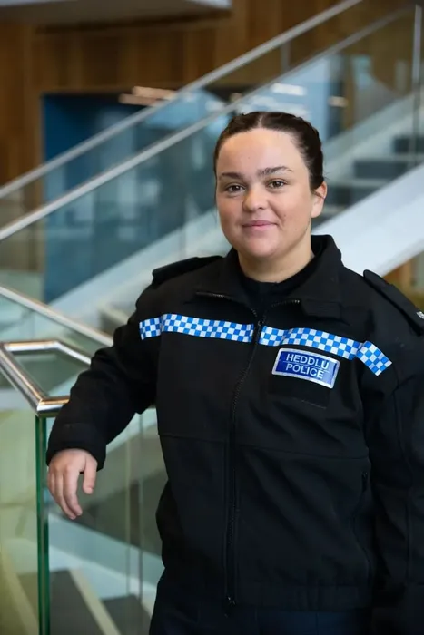 Professional Policing graduate, Saffron, poses for a profile picture whilst wearing her South Wales police uniform