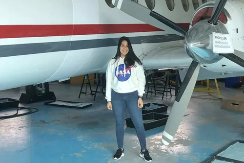 MSc Aviation Engineering and Management student Lerined Sanchez stands in front of a small aircraft in the Aviation Centre at USW's Treforest Campus