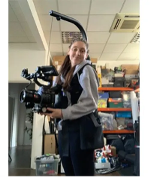 Student Zoe, takes a selife whilst wearing camera equipment during her placement at Storm and Shelter