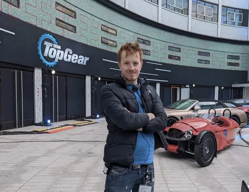 Callum Parfitt stood with his arms crossed on the Top Gear film set