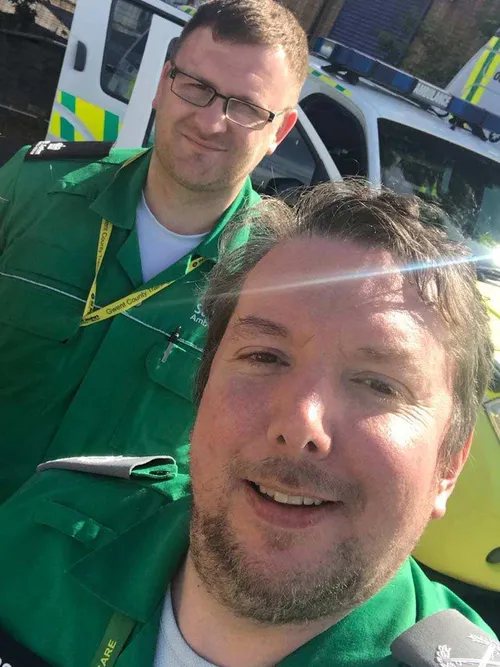 Nursing graduate, Gaz wearing his paramedic uniform with a colleague