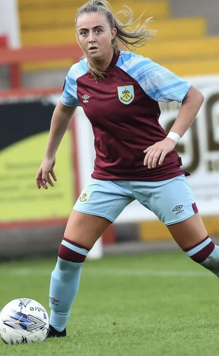 Graduate, Megan Dykes, playing football.