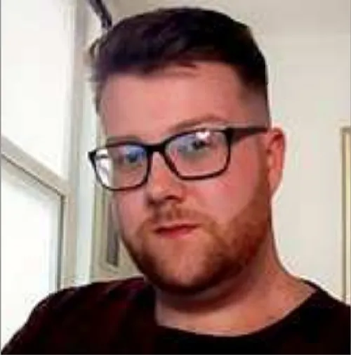 Alumnus Adam Williams looks at the camera
