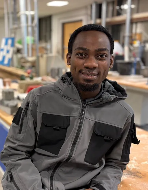 Immanuel Rwandalla sitting in the concrete labs at the University of South Wales