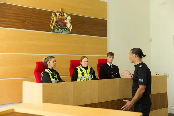 Policing students conducting a role play in the moot courtroom