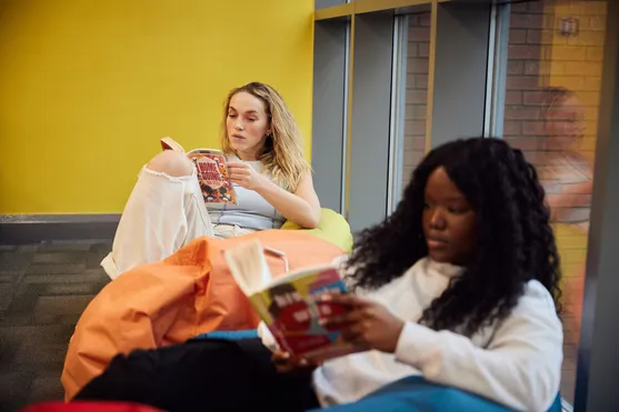 Two students studying in the Treforest library.