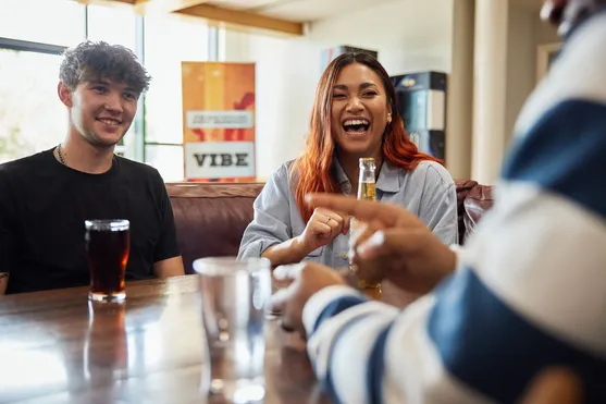A group of students sat laughing over drinks at Treforest Student's Union