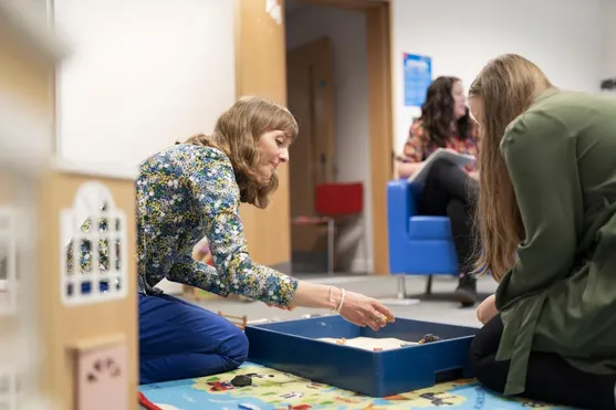 Students experimenting with toys and sand as a counselling technique
