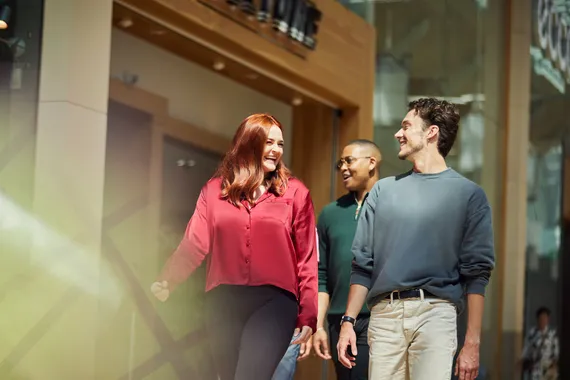 Three students walking through St David's shopping centre.