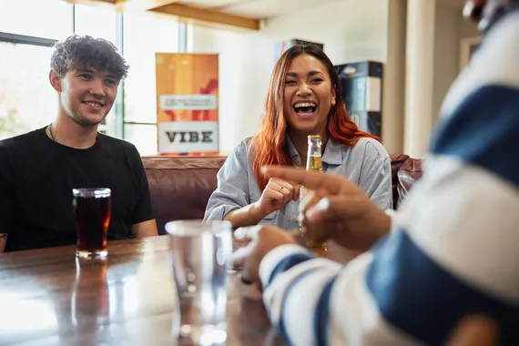 A group of students sat laughing over drinks at Treforest Student's Union