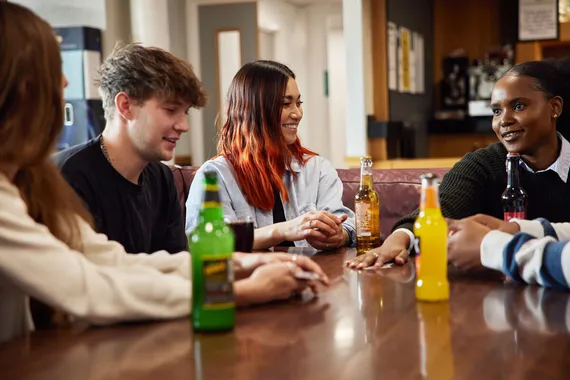 A group of students sat talking over drinks at Treforest Student's Union