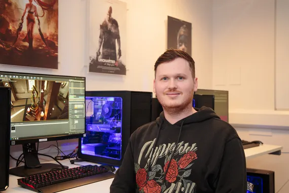 A computing student smiling at the camera
