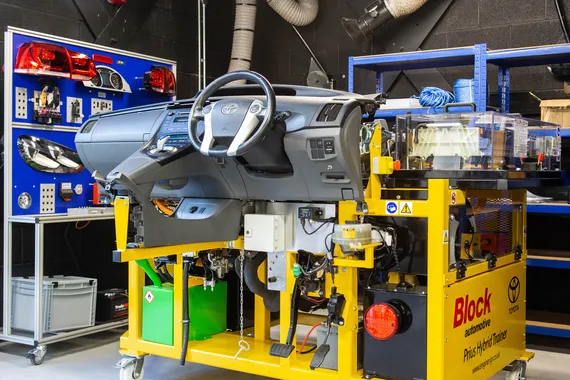 A piece of automotive engineering equipment consisting of a car dashboard against a metal rack in a USW laboratory