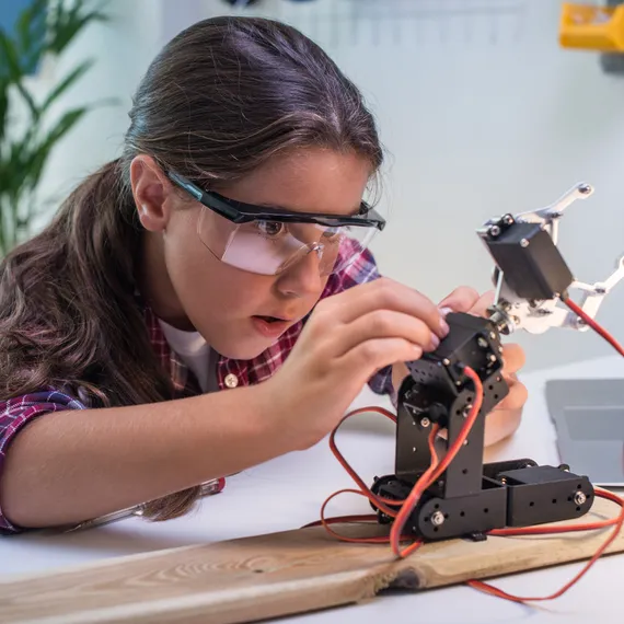Girl building robot