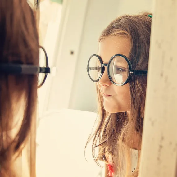 Young girl looking in the mirror