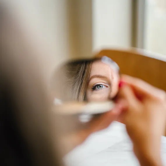 Girl looking in the mirror
