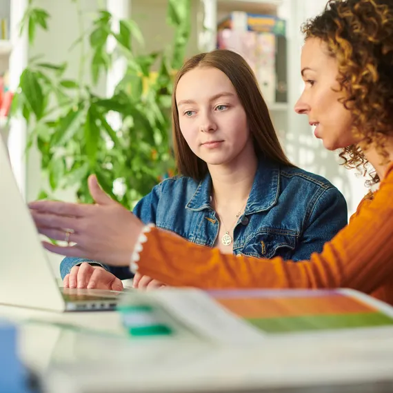 Women with girl on laptop