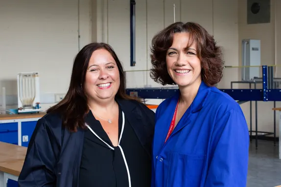 Two women in engineering smiling at the camera