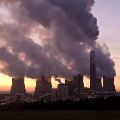 Coal power station with billowing steam coming out of the stacks