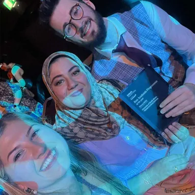 Dr Rebecca Peters, Dr Mabrouka Abuhmida and Ieuan Griffiths smile with award