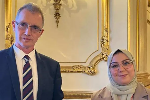 Welsh Secretary David Davies and Dr Mabrouka Abuhmida smiling at the camera at Lancaster House in London.
