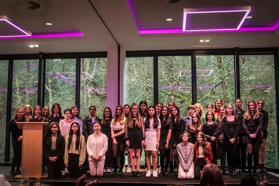 A large group of young people stood on a stage