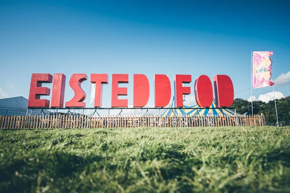The red Eisteddfod letters in a field