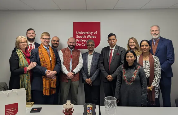 A group of 11 people, all smiling for the camera.