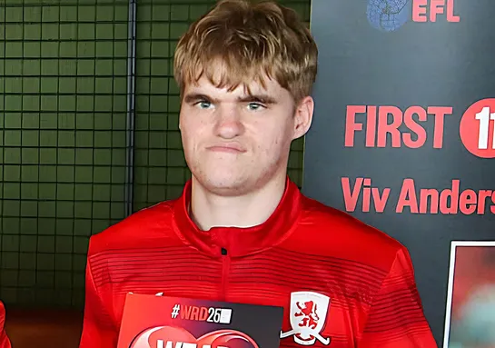 Elliot is wearing a red football kit