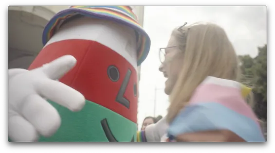 A person smiling as they go towards Mr Urdd.