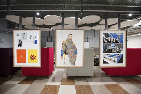 Communal campus space with student work showcased.