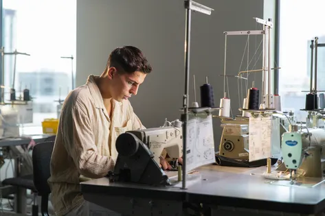A student is working at a sewing machine.
