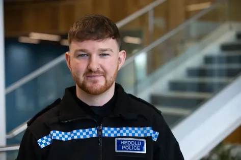 Professional Policing graduate, Andre, poses for a profile picture whilst wearing his South Wales police uniform