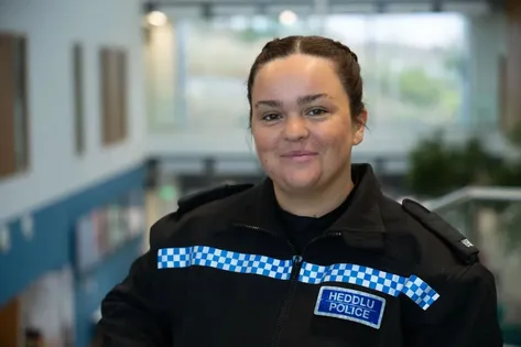 Professional Policing graduate, Saffron, poses for a profile picture whilst wearing her South Wales police uniform