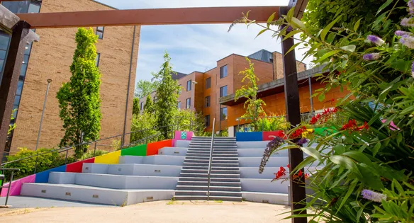 A colourful staircase and ourdoor social area leading up to the accommodation blocks at Treforest campus.