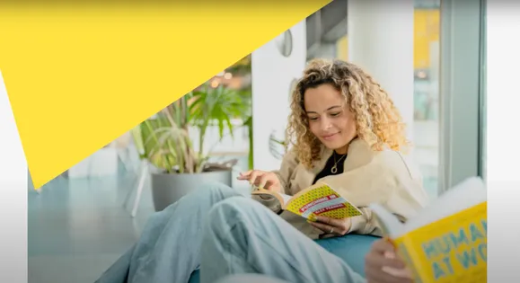 person sat in a library reading a book