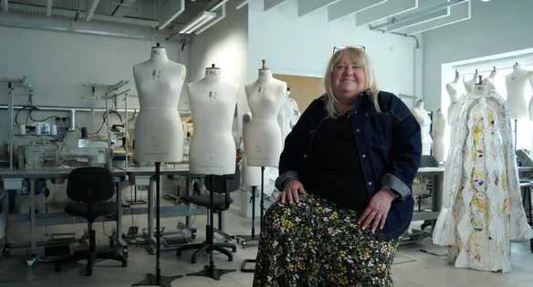 Staff sat in fashion studios smiling