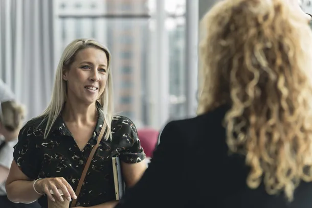 Two people in conversation at the University of South Wales