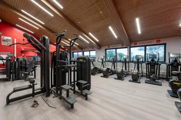 FitZone gym in Pontypridd - equipped gym interior with various exercise machines under bright lighting.