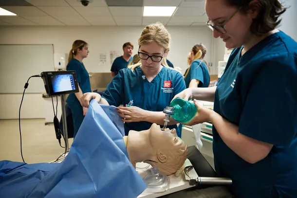 Students practising technical skills in a theatre setting.