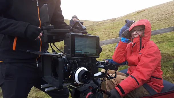 Students filming with camera equipment on a mountain