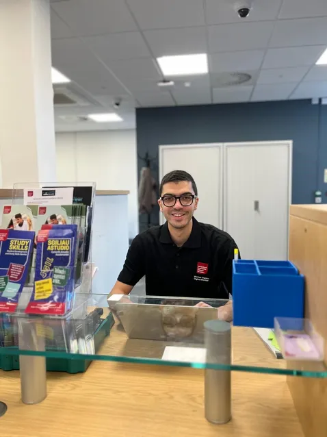 Member of Learner Development Service staff sitting behind a desk